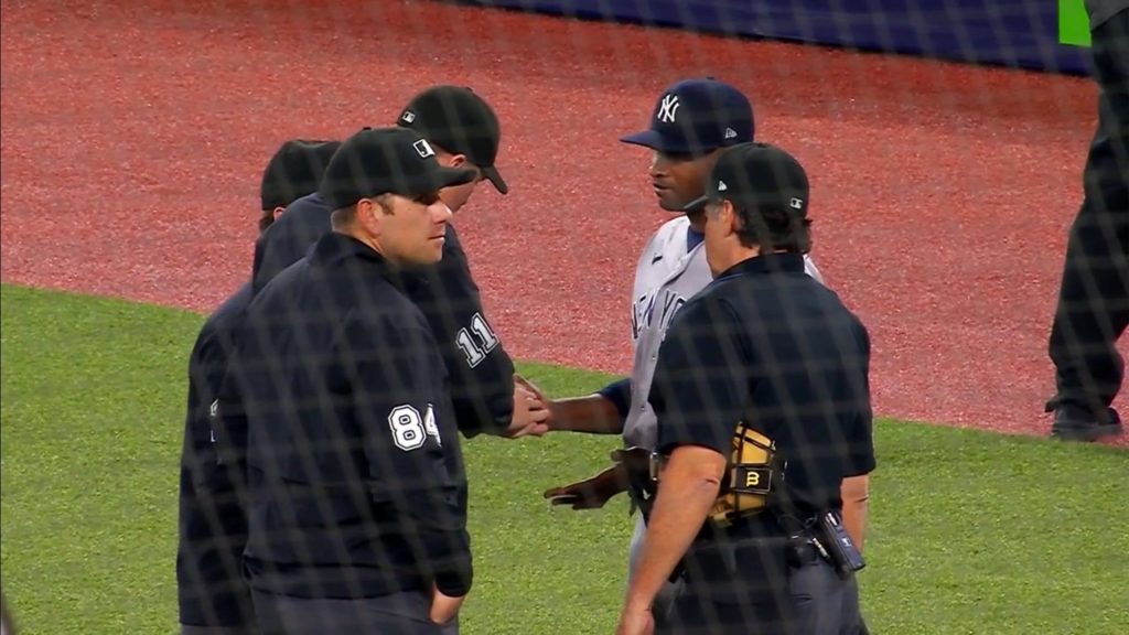 Domingo German Discussing His Hand Substance With The Umpires.